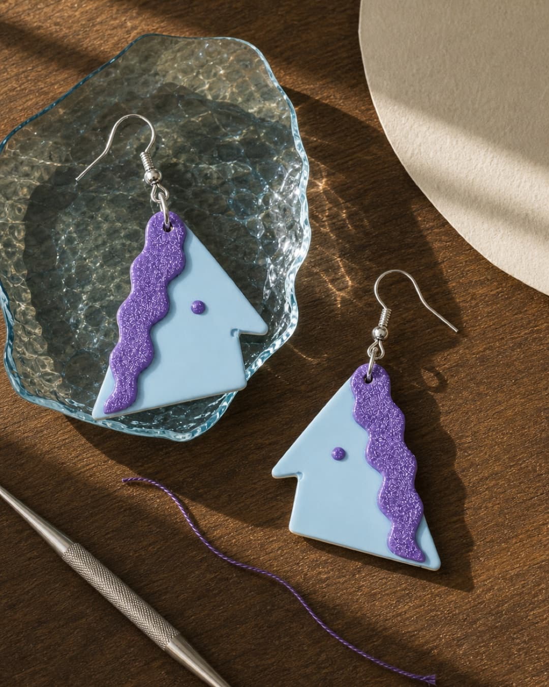 Lilac Ice Triangle Dangles in a glass and walnut still life