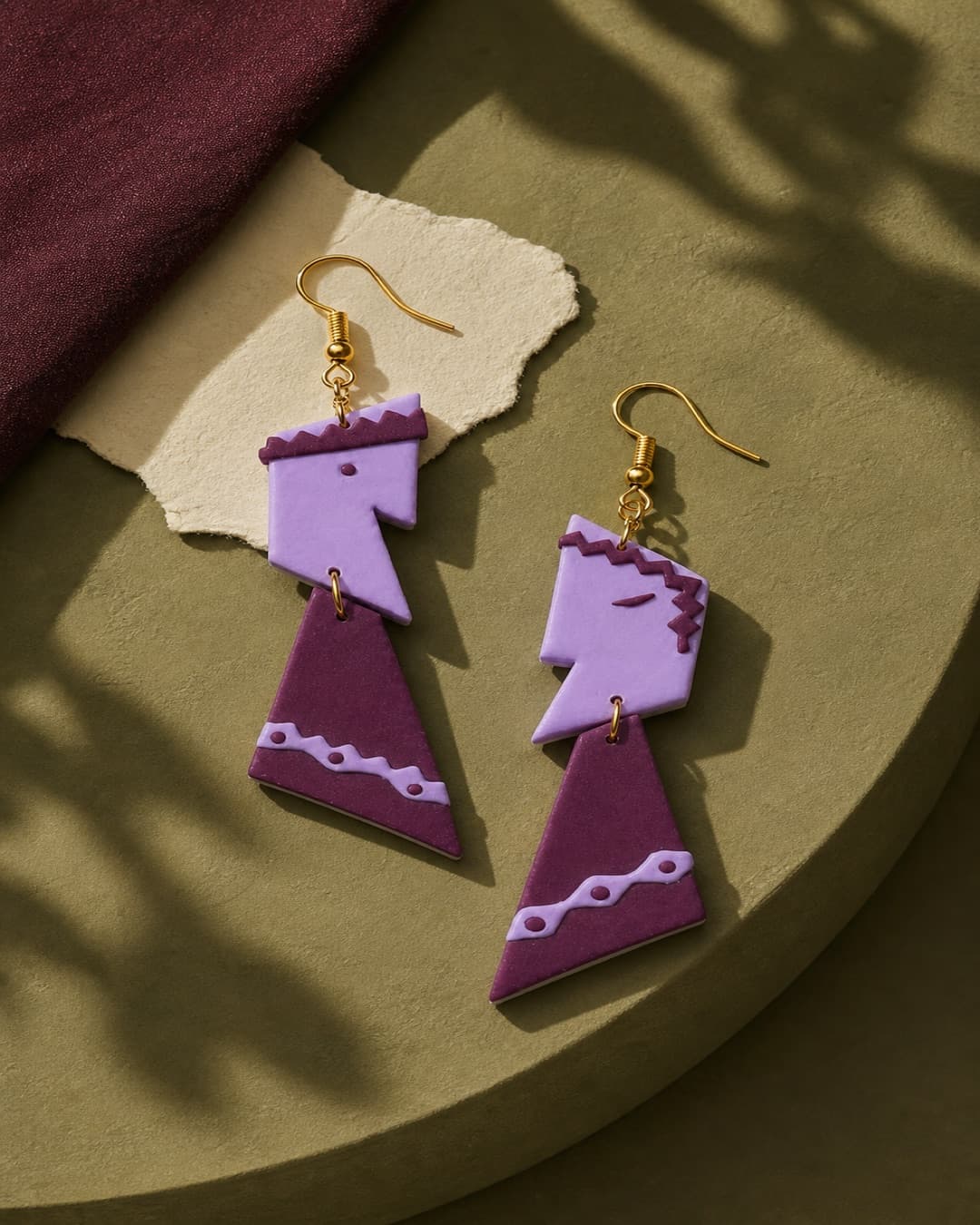 Lilac Lightning Dangles as a pair in a warm studio still life