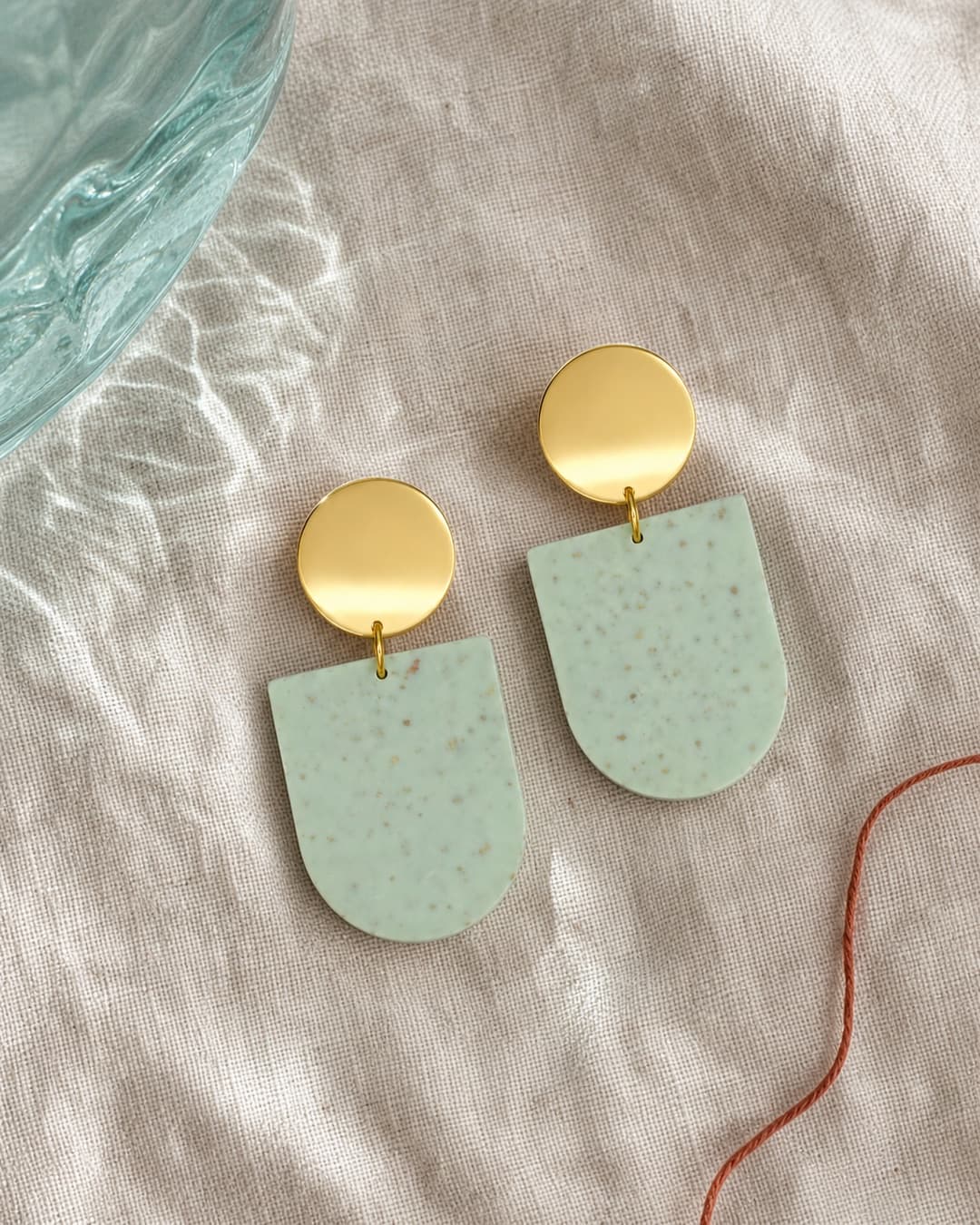 Speckled Mint Plate Dangles in a glass and linen still life