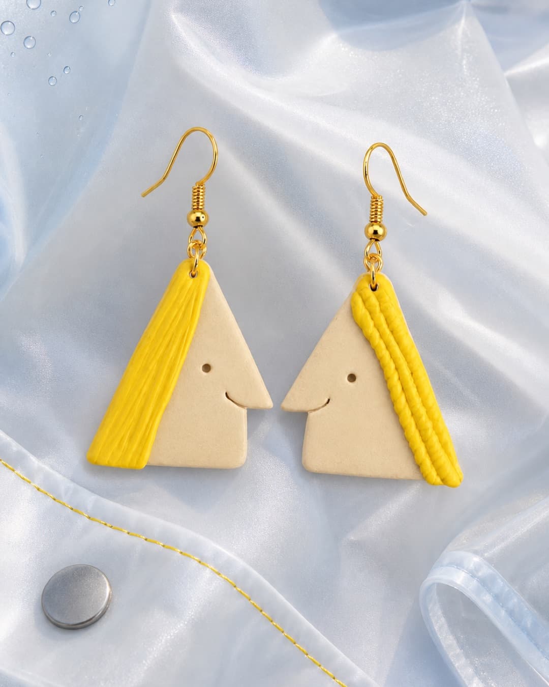 Yellow Triangle Face Dangles in a raincoat-pocket still life
